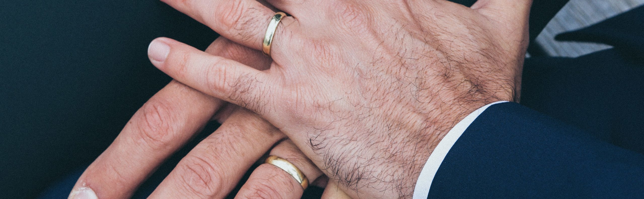 two men showing wedding rings